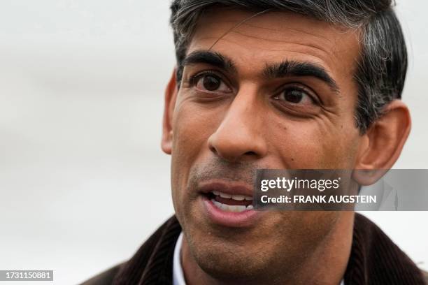 Britain's Prime Minister Rishi Sunak speaks to a TV reporter during a visit to Clacton-on-Sea, south east England, on October 18, 2023.