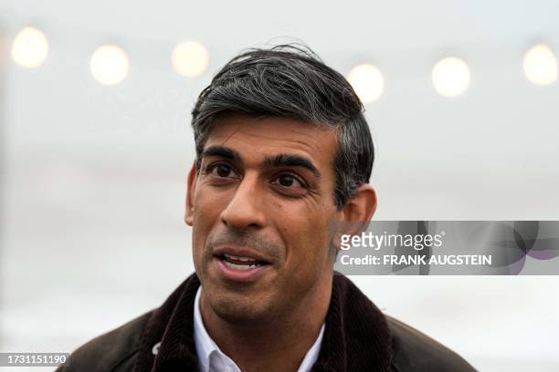 Britain's Prime Minister Rishi Sunak speaks to a TV reporter during a visit to Clacton-on-Sea, south east England, on October 18, 2023.