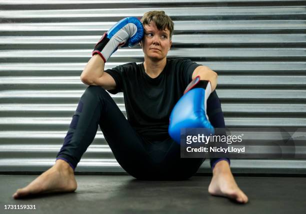 mid adult woman boxer taking break after boxing workout session in the gym - south africa training session stock pictures, royalty-free photos & images
