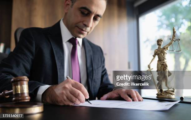 judge or legal advisor lawyer examining and signing legal documents. - writing instrument bildbanksfoton och bilder