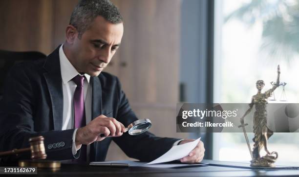 judge or legal advisor lawyer examining and signing legal documents. - judges robe stock pictures, royalty-free photos & images