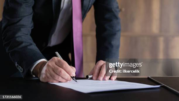 judge or legal advisor lawyer examining and signing legal documents. - testemunha imagens e fotografias de stock