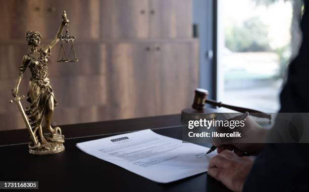 judge or legal advisor lawyer examining and signing legal documents. - aviso legal imagens e fotografias de stock
