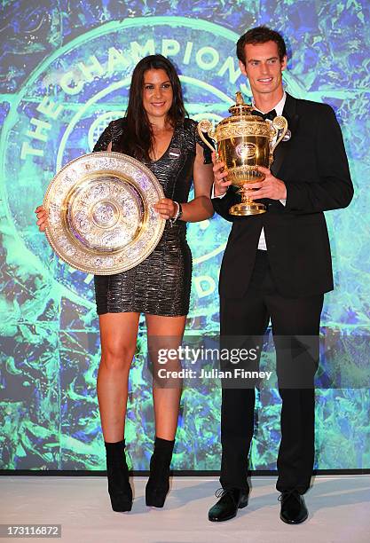 Marion Bartoli of France poses with the Venus Rosewater Dish trophy and Andy Murray of Great Britain poses with the Gentlemen's Singles Trophy at the...