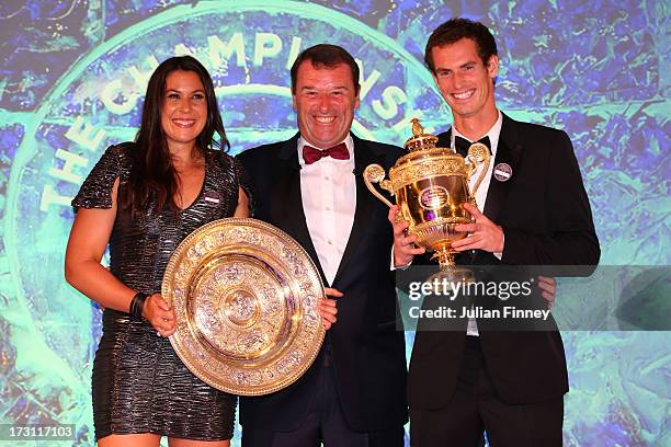 Philip Brook, the Wimbledon chairman and Marion Bartoli of France posing with the Venus Rosewater Dish trophy and Andy Murray of Great Britain posing...