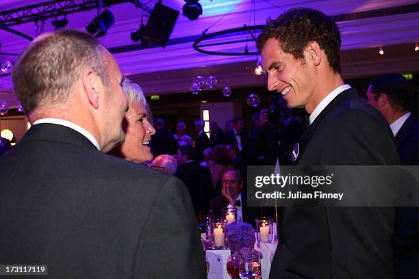 Gentlemen's Singles Champion Andy Murray of Great Britain speaks to his parents Judy Murray and William Murray during the Wimbledon Championships...