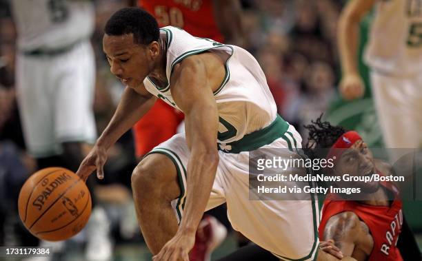 Boston Celtics shooting guard Avery Bradley moves away from Toronto Raptors small forward James Johnson in the second quarter of an NBA game against...
