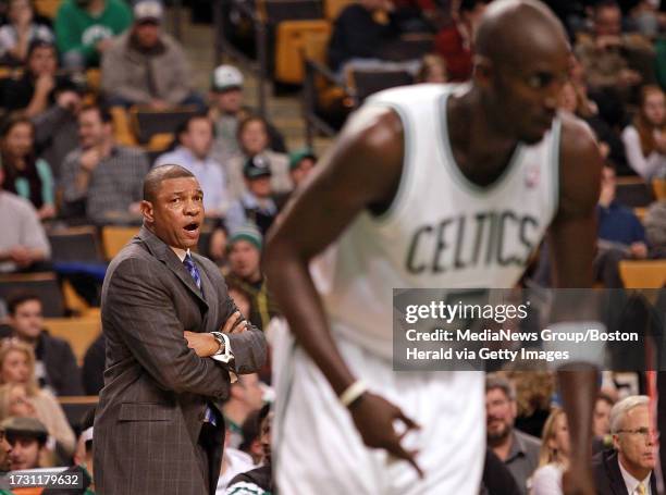 Boston Celtics head coach Doc Rivers looks over at power forward Kevin Garnett in the second half of a preseason NBA game against the Toronto Raptors...