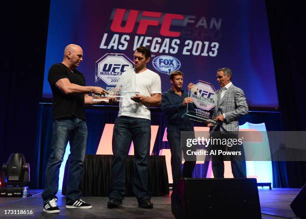 President Dana White and television producer Craig Piligian present Forrest Griffin and Stephan Bonnar with their UFC Hall of Fame plaques during the...