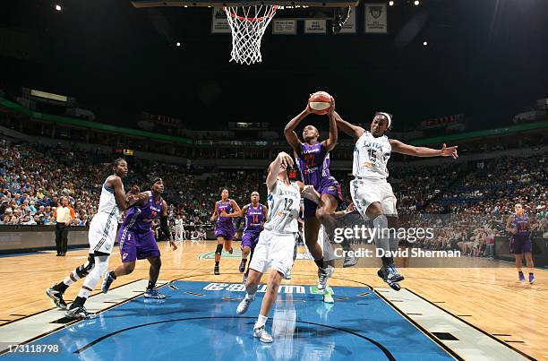 Charde Houston of the the Phoenix Mercury shoots against Rachel Jarry and Ta'Shauna ''Sugar'' Rodgers of the Minnesota Lynx during the WNBA game on...