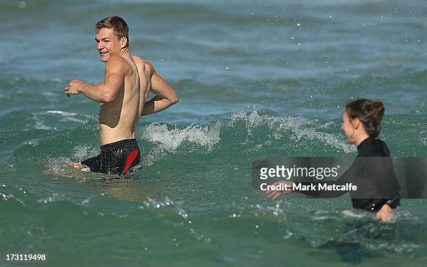 Brandon Jack reacts to being splashed by a girl during a Sydney Swans AFL recovery session at Borth Bondi Beach on July 8, 2013 in Sydney, Australia.