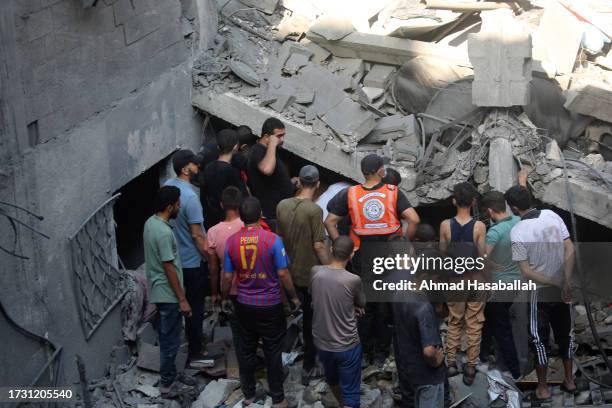 Palestinian citizens inspect damage to their homes caused by Israeli airstrikes on October 12, 2023 in Gaza City, Gaza. At least 1,200 people,...