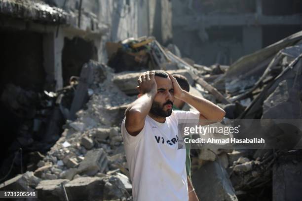 Palestinian citizens inspect damage to their homes caused by Israeli airstrikes on October 12, 2023 in Gaza City, Gaza. At least 1,200 people,...