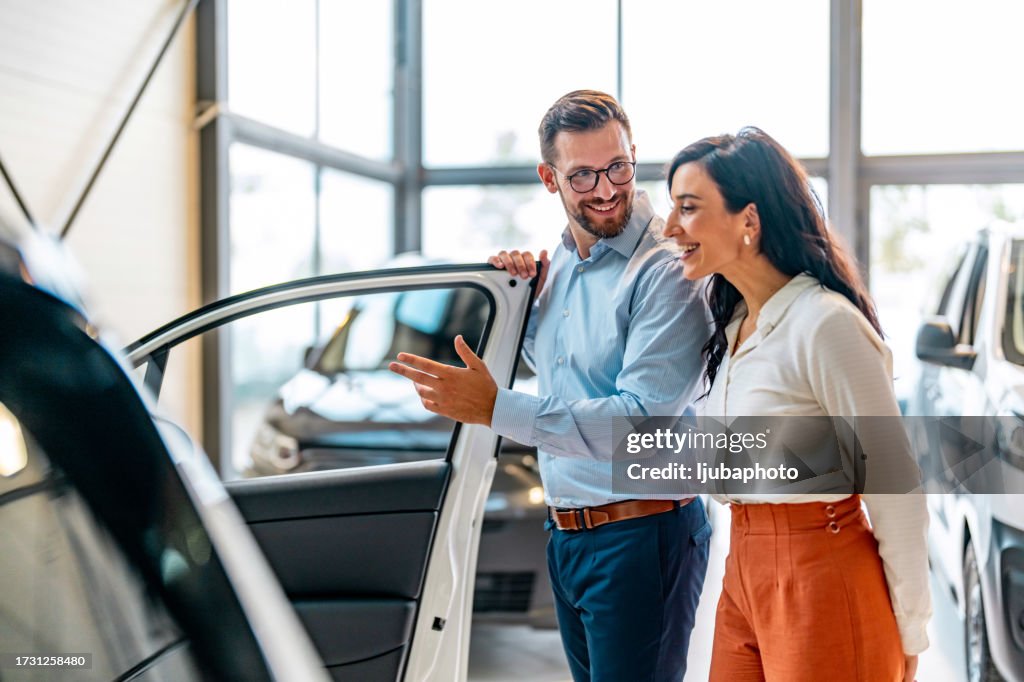 Customer and a salesperson in the car showroom