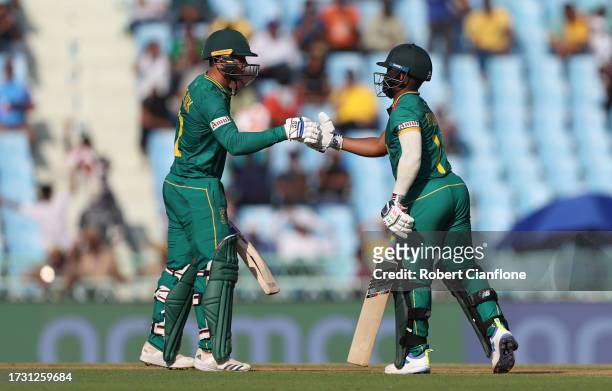 Quinton de Kock and Temba Bavuma of South Africa interact during the ICC Men's Cricket World Cup India 2023 between Australia and South Africa at...