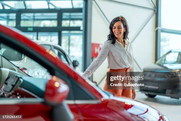 businesswoman choosing a new car. - car buying stock pictures, royalty-free photos & images