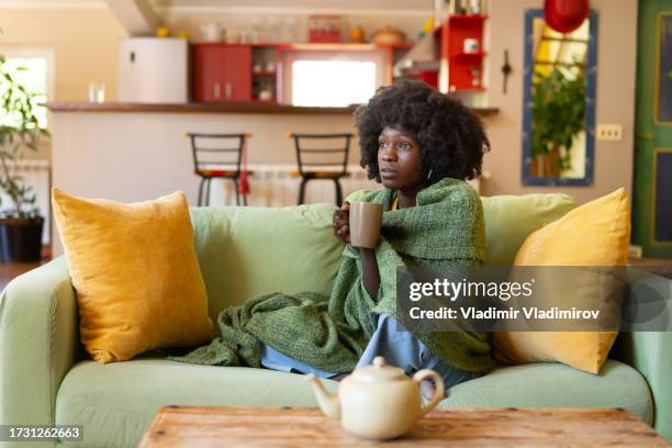 woman encased in a blanket, with a hot drink - winter blues stock pictures, royalty-free photos & images