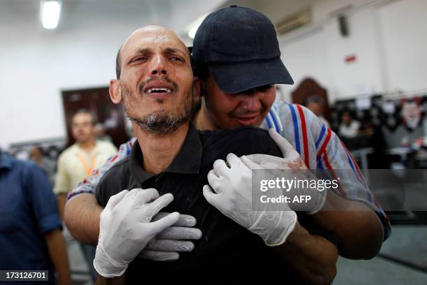 Man grieves at a make shift hospital where victims are being brought following clashes between Egyptian police and Muslim Brotherhood supporters of...