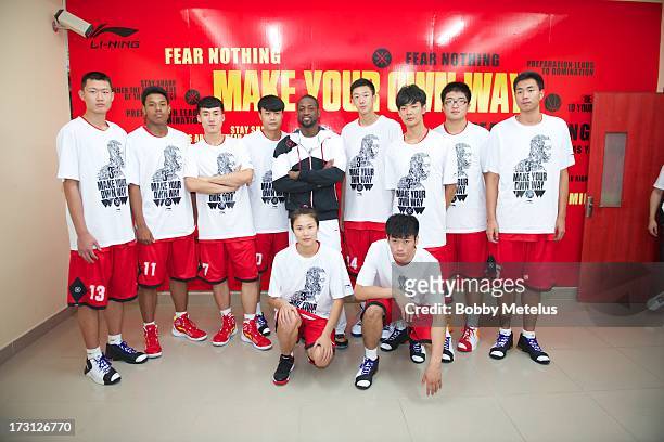 Dwyane Wade poses with the Beijing High School All-Star team at Guangzhou Sports University on July 7, 2013 in Guangzhou, China.