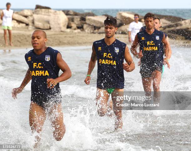 Jonathan Biabiany, Pedro Mendes and Antonio Mirante of Parma FC train on the shore-line during a Parma FC pre-season training session at Rosa Marina...