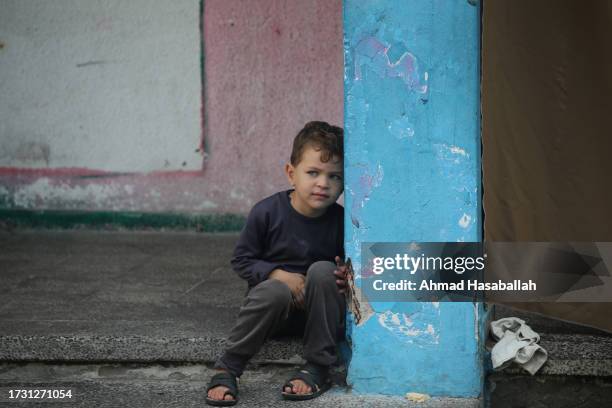 Displaced Palestinian citizens gather at the UNRWA Beach School, after evacuating their homes damaged by Israeli air strikes, on October 12, 2023 in...