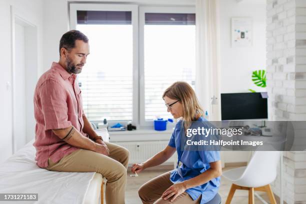 doctor testing patient’s reflexes, using reflex hammer. - neuropathy stock pictures, royalty-free photos & images