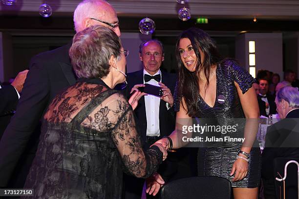 Ladies' Singles champion, Marion Bartoli of France greets guests as her father Walter Bartoli looks on during the Wimbledon Championships 2013...