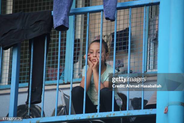 Displaced Palestinian citizens gather at the UNRWA Beach School, after evacuating their homes damaged by Israeli air strikes, on October 12, 2023 in...