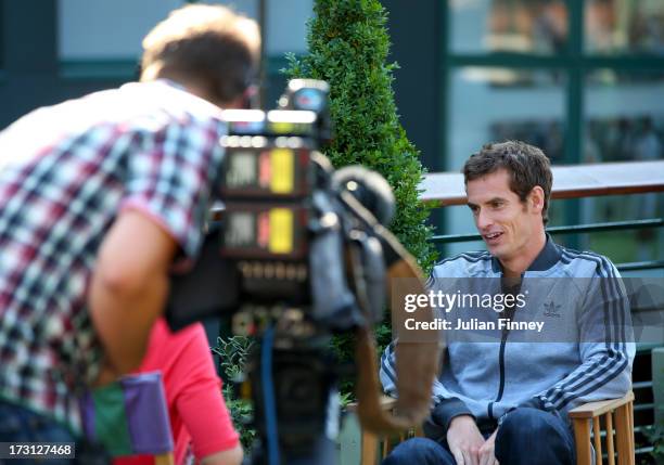 Andy Murray of Great Britain talks to the media at Wimbledon on July 8, 2013 in London, England.