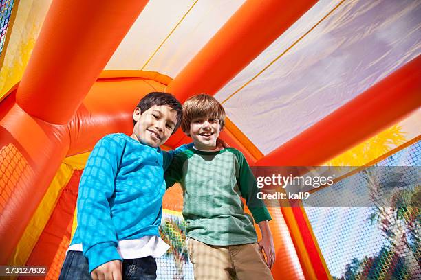 jungen in bounce house - schulfest stock-fotos und bilder