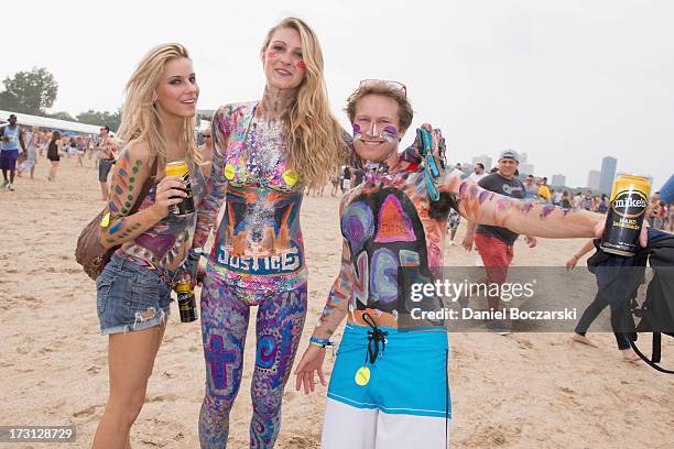 Body painted festival-goers pose during the 2013 Wavefront Music Festival at Montrose Beach on July 7, 2013 in Chicago, Illinois.