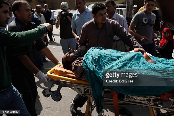 The body of an Egyptian man lies on a stretcher at the Liltaqmeen al-Sahy Hospital in Cairo's Nasr City district, after allegedly being killed during...