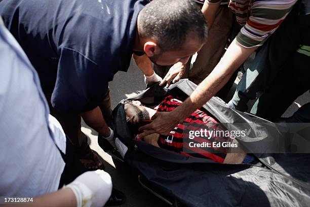 The body of a man lies in a body bag at the Liltaqmeen al-Sahy Hospital in Cairo's Nasr City district, after allegedly being killed during a shooting...