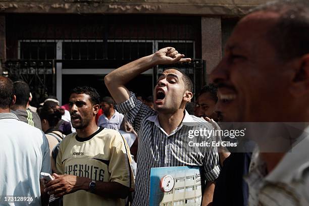 Man reacts after seeing the body of a slain protester at the Liltaqmeen al-Sahy Hospital in Cairo's Nasr City district, allegedly killed during a...