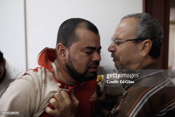 Man reacts after seeing the body of a family member at the Liltaqmeen al-Sahy Hospital in Cairo's Nasr City district, allegedly killed during a...