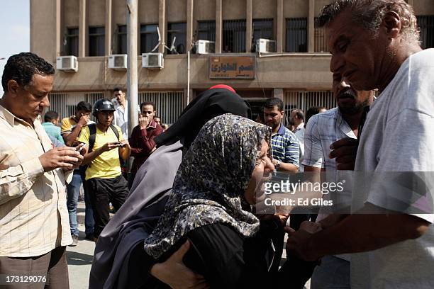 Woman reacts after seeing the body of a slain protester at the Liltaqmeen al-Sahy Hospital in Cairo's Nasr City district, allegedly killed during a...