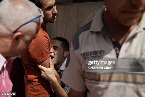 Man reacts after seeing the body of a family member at the Liltaqmeen al-Sahy Hospital in Cairo's Nasr City district, allegedly killed during a...