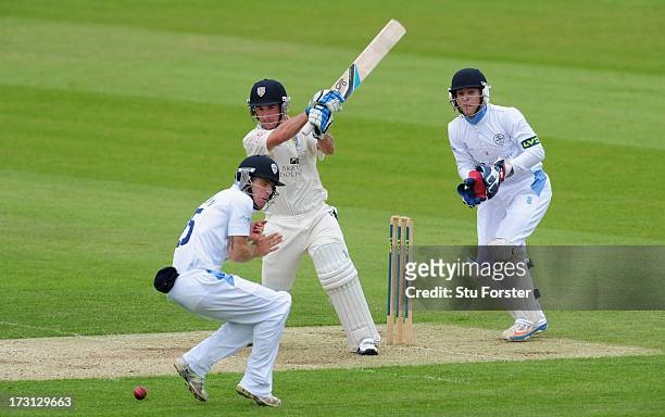 Durham batsman Will Smith pulls a ball towards the boundary past fielder Richard Johnson as keeper Tom Poynton looks on during day one of the LV...