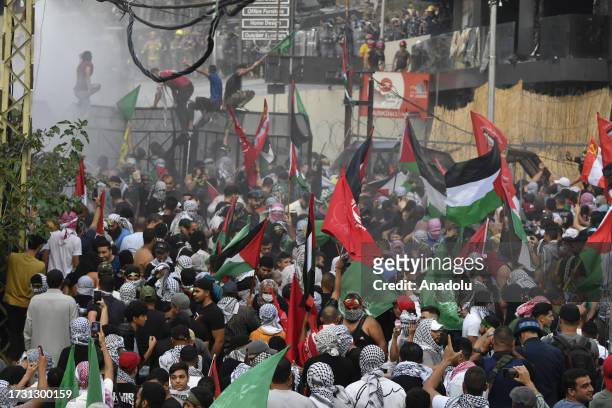People, carrying the Palestinian flag and banners, gather in front of the US Embassy to protest against the Israeli attacks on Gaza in Beirut,...