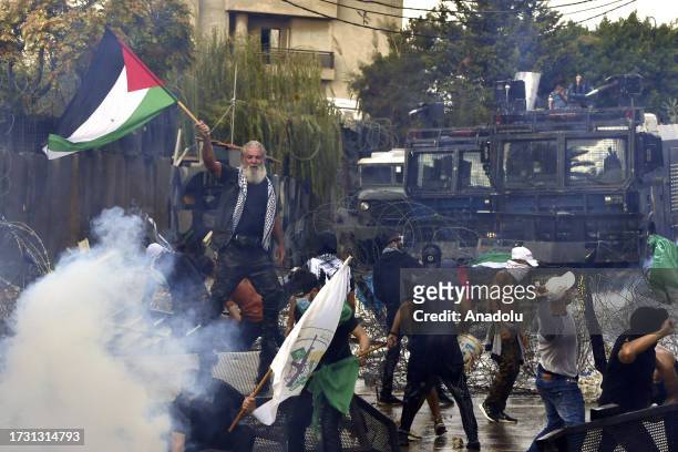 Man, carrying a Palestinian flag, shouts slogans as people gather in front of the US Embassy to protest against the Israeli attacks on Gaza in...