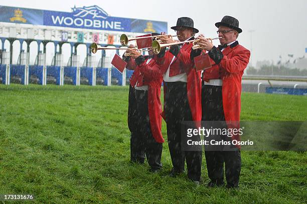 Buglers play during a downpour at Sunday's Queen's Plate at Woodbine racetrack.