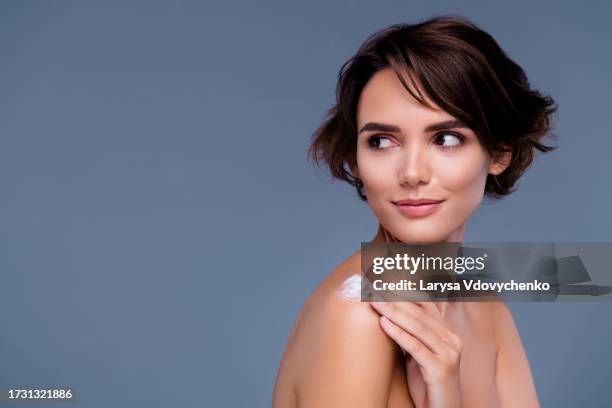 photo of lady have morning hygiene applying touch wellness lotion on shoulder  over grey background - lady grey background bildbanksfoton och bilder