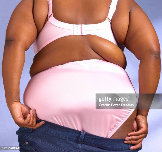 large woman getting dressed - pink pants stock pictures, royalty-free photos & images