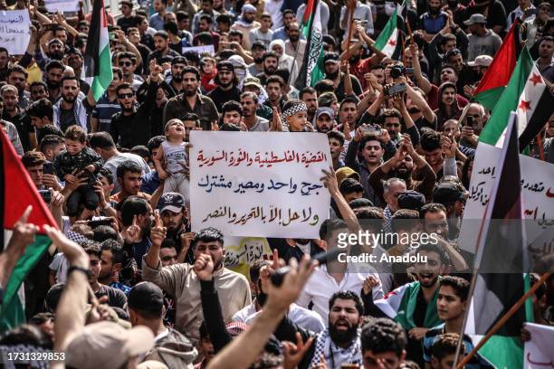 People gather to stage a demonstration to express their solidarity with Palestinians and protest Israel's military actions in Atme town of Idlib,...