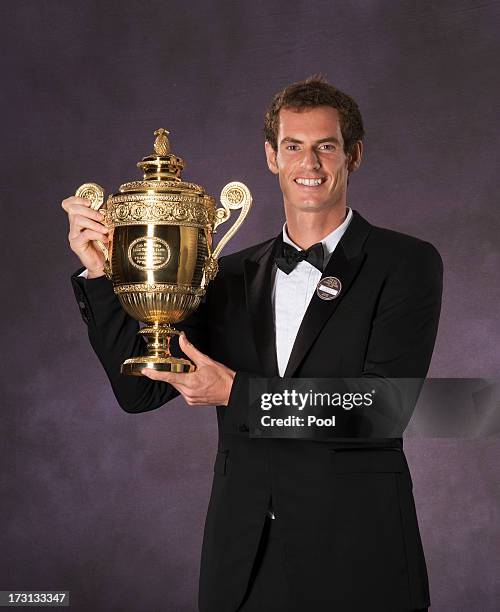 Andy Murray of Great Britain poses with the Gentlemen's Singles Trophy at the Wimbledon Championships 2013 Winners Ball at InterContinental Park Lane...