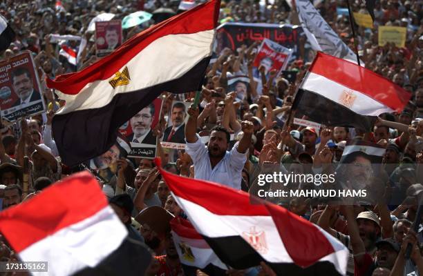 Egyptian supporters of deposed president Mohamed Morsi wave their national flag as they attend a rally in support of the former Islamist leader...