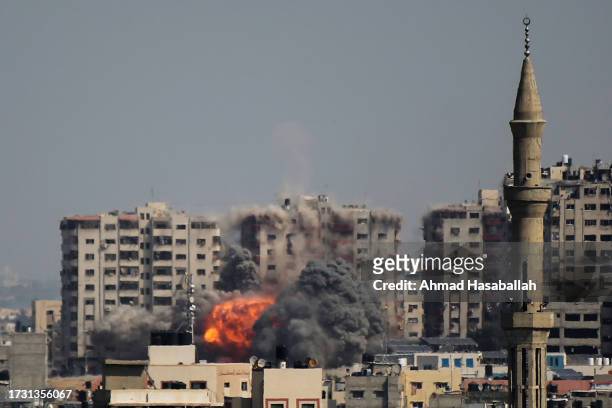 An explosion on a residential tower caused by Israeli air raids in the northern Gaza Strip on October 12, 2023 in Gaza City, Gaza. At least 1,200...