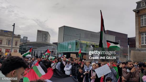 People attend a pro Palestinian solidarity action at the Martelarenplein in Leuven, on October 18, 2023. A strike on a Gaza hospital compound which...