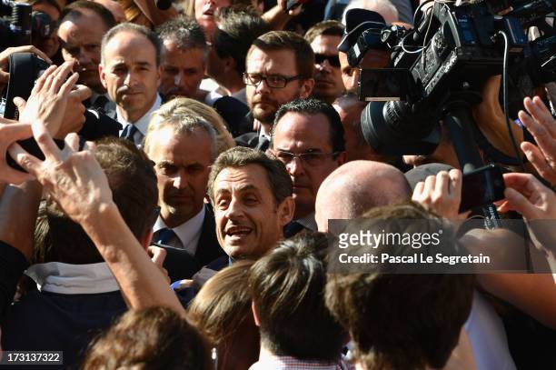 President of the UMP Jean-Francois Cope and former French President Nicolas Sarkozy departs from UMP headquarters after an extraodinaty meeting of...