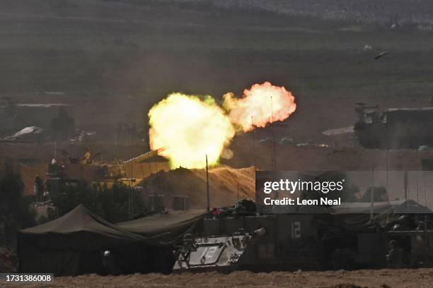 Israeli artillery fire rounds into the Gaza Strip from the border on October 12, 2023 near Sderot, Israel. Israel has sealed off Gaza and conducted...